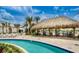 Relaxing lazy river with a charming tiki hut and seating area for residents at 3120 Paradox Cir # 101, Kissimmee, FL 34746