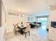 Open-concept living room and dining area with modern furnishings and lots of natural light at 3120 Paradox Cir # 101, Kissimmee, FL 34746