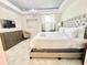 Bright main bedroom featuring stylish decor, a plush bed, and a serene atmosphere at 3120 Paradox Cir # 101, Kissimmee, FL 34746