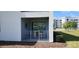 Outdoor patio with seating and a view of the well-manicured landscape surrounding the modern apartment complex at 3120 Paradox Cir # 101, Kissimmee, FL 34746