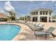 Resort-style community pool with lounge chairs and a covered pavilion for relaxation at 3120 Paradox Cir # 101, Kissimmee, FL 34746