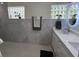 Bright bathroom featuring dual glass block windows and a vanity with white cabinets at 3131 Lowndes Dr, Winter Park, FL 32792