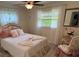 Bright bedroom with a floral accent bed, side table, and natural light at 3131 Lowndes Dr, Winter Park, FL 32792