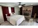 Inviting bedroom with a decorative fireplace, ceiling fan, and comfortable seating at 3131 Lowndes Dr, Winter Park, FL 32792