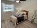 Cozy bedroom featuring wood-look flooring, neutral tones, and a comfortable bed at 3131 Lowndes Dr, Winter Park, FL 32792