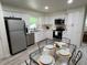 Modern eat-in kitchen with white cabinets, stainless steel appliances, and updated countertops at 3131 Lowndes Dr, Winter Park, FL 32792