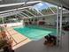 Screened-in pool area with a large pool and plenty of space for outdoor entertaining at 3131 Lowndes Dr, Winter Park, FL 32792
