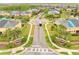 Aerial view showcases a residential community's street, sidewalks, landscaping, signage, and well-maintained homes at 3166 Rodrick Cir, Orlando, FL 32824