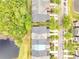 An aerial view of rooftops near a peaceful pond with a lush tree line, highlighting the neighborhood's serenity at 3166 Rodrick Cir, Orlando, FL 32824