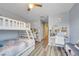 bedroom with bunk beds, study desks, and wood laminate flooring at 3166 Rodrick Cir, Orlando, FL 32824