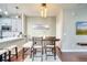 Dining area with stylish lighting, a modern table, and seamless transition to the kitchen at 3166 Rodrick Cir, Orlando, FL 32824