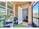Inviting screened-in patio with two chairs, a glass table, and ambient lighting, leading to a door and interior staircase at 3166 Rodrick Cir, Orlando, FL 32824