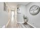 Hallway boasts modern artwork, luxury vinyl flooring, and neutral paint at 3166 Rodrick Cir, Orlando, FL 32824