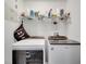 Well-organized laundry room featuring a front-load washer and dryer with storage shelf above at 3166 Rodrick Cir, Orlando, FL 32824