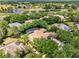 Scenic aerial view of a home overlooking a serene lake and golf course amidst a lush, green landscape at 32613 View Haven Ln, Sorrento, FL 32776