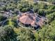 Overhead view of a sprawling community clubhouse showcasing beautiful architecture and surrounded by mature trees at 32613 View Haven Ln, Sorrento, FL 32776