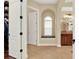 Bright bathroom featuring a garden tub with an arched window and a separate glass shower at 32613 View Haven Ln, Sorrento, FL 32776