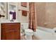 Cozy bathroom featuring a tub/shower combo with tile surround, toilet, and vanity with wood cabinets at 32613 View Haven Ln, Sorrento, FL 32776