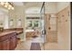Elegant bathroom featuring a glass shower, tub, and granite countertops at 32613 View Haven Ln, Sorrento, FL 32776
