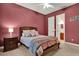 Bedroom boasts mauve walls and an ensuite bathroom, creating a comfortable retreat at 32613 View Haven Ln, Sorrento, FL 32776