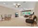 Large bonus room offers versatile space with multiple ceiling fans, tv, dining, and living areas at 32613 View Haven Ln, Sorrento, FL 32776