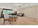 Spacious bonus room with ceiling fans, a dining table, and comfortable lounge seating at 32613 View Haven Ln, Sorrento, FL 32776