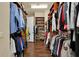 Large walk-in closet with custom cabinetry, wooden floors, and custom shelving and storage at 32613 View Haven Ln, Sorrento, FL 32776