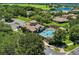Overhead shot of the community pool area, with inviting blue water, lounge chairs, and meticulous landscaping at 32613 View Haven Ln, Sorrento, FL 32776