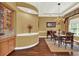 Dining room with decorative chandelier, hardwood floors, large window, and views of the front yard at 32613 View Haven Ln, Sorrento, FL 32776