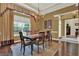 Dining room with decorative chandelier, hardwood floors, large window, and views of the front yard at 32613 View Haven Ln, Sorrento, FL 32776