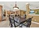 Open dining area with access to the kitchen and living room, featuring a large dining table and chandelier at 32613 View Haven Ln, Sorrento, FL 32776