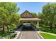 Covered entrance to a luxury community featuring stone pillars, wood accents, and a well manicured landscape at 32613 View Haven Ln, Sorrento, FL 32776