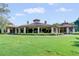 Elegant clubhouse exterior with a circular design, set against a backdrop of meticulously maintained landscaping at 32613 View Haven Ln, Sorrento, FL 32776
