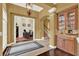 Inviting foyer featuring an elegant chandelier, tiled floors, stairway access, and a view into the home office at 32613 View Haven Ln, Sorrento, FL 32776