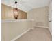 Hallway features decorative lighting, neutral paint, and white trim creating a clean and bright space at 32613 View Haven Ln, Sorrento, FL 32776