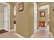 Hallway with tile floors, wall art, and an arched entry way to a different room in the house at 32613 View Haven Ln, Sorrento, FL 32776