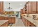 Spacious kitchen featuring custom wood cabinets, granite countertops, tile backsplash, and modern stainless steel appliances at 32613 View Haven Ln, Sorrento, FL 32776