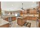 Open concept kitchen with an island, granite countertops, stainless steel appliances, and custom wood cabinets at 32613 View Haven Ln, Sorrento, FL 32776