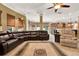 Open-concept living room with a large sectional sofa, direct access to the kitchen, and neutral tile floors at 32613 View Haven Ln, Sorrento, FL 32776