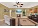 Comfortable living room featuring a fireplace, built-in shelving, a mounted TV, and sliding window shades at 32613 View Haven Ln, Sorrento, FL 32776