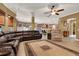 Open-concept layout with access to the kitchen, a large sectional sofa, tiled flooring, and modern lighting at 32613 View Haven Ln, Sorrento, FL 32776