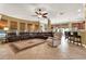 Spacious living room features a large sectional sofa, tiled flooring, and seamless access to the dining area at 32613 View Haven Ln, Sorrento, FL 32776