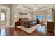 Main bedroom boasts wood floors, a ceiling fan, and an ensuite bathroom at 32613 View Haven Ln, Sorrento, FL 32776