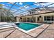 Screened-in pool and patio with a brick deck, a bar, and outdoor furniture for luxurious outdoor living at 32613 View Haven Ln, Sorrento, FL 32776