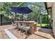 Charming pool bar with stone accents, plenty of seating and a shaded umbrella for comfortable outdoor gatherings at 32613 View Haven Ln, Sorrento, FL 32776