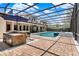 An inviting pool with a swim-up bar with stone accents, and a patio area perfect for entertaining at 32613 View Haven Ln, Sorrento, FL 32776
