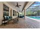 Inviting screened-in pool area with a spa, patio seating, and lush landscaping offering privacy at 32613 View Haven Ln, Sorrento, FL 32776