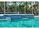 Close-up view of a pool waterfall feature with vibrant blue tiles and clear, refreshing water at 32613 View Haven Ln, Sorrento, FL 32776