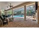 Beautiful screened-in pool area with a spa, outdoor bar, and ample seating for entertaining guests at 32613 View Haven Ln, Sorrento, FL 32776