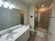 Bright bathroom featuring a shower with glass door and a vanity with white cabinets at 3399 Buoy Cir, Winter Garden, FL 34787